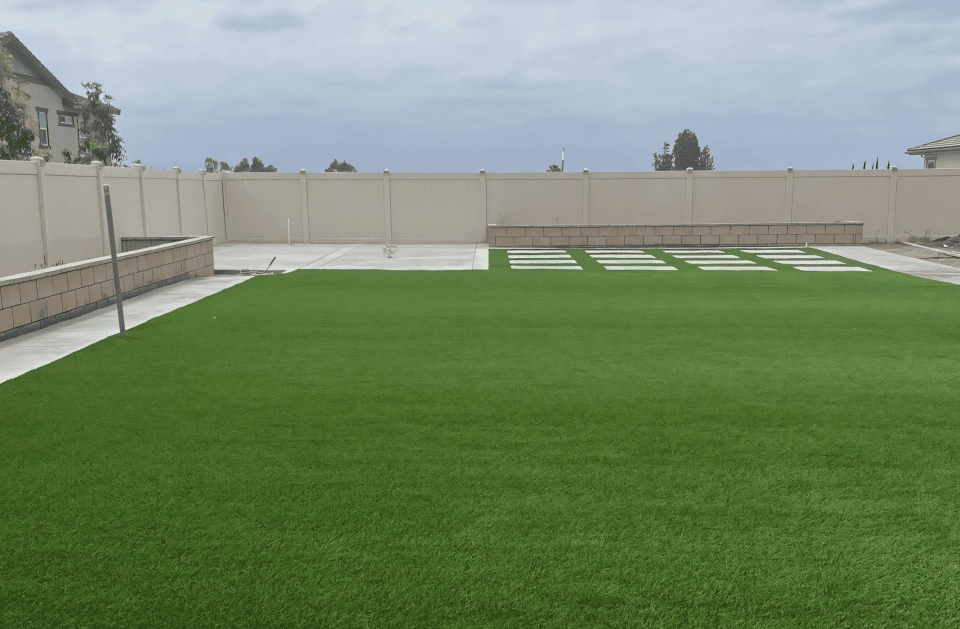 Completed artificial turf yard with stepping-stone accents